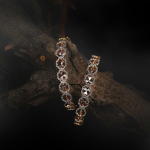 Exquisite diamond bracelets showcasing intricate designs on a rustic wooden branch.