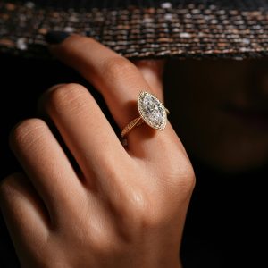 A stylish diamond ring adorns a young woman's hand, showcasing premium jewellery fashion.
